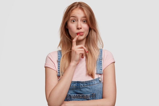 Blonde woman wearing denim overalls