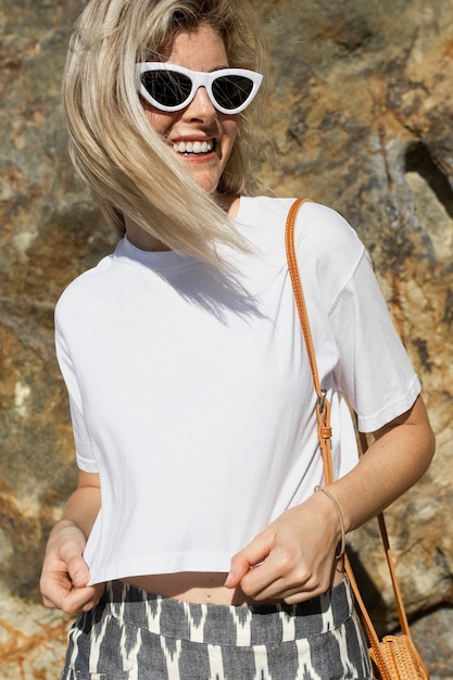 Free Photo blonde woman in white t-shirt summer fashion outdoor portrait