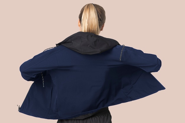 Free photo blonde woman in windbreaker jacket for sportswear fashion photoshoot rear view