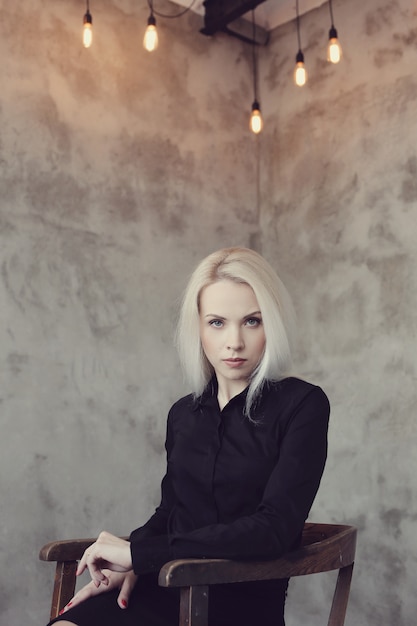 Free photo blonde woman with black dress posing