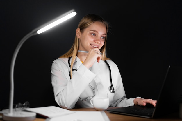 Blonde woman working on laptop