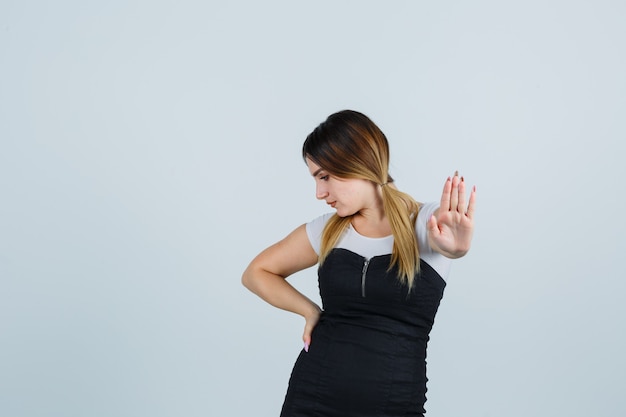 Free photo blonde young lady in dress gesturing isolated