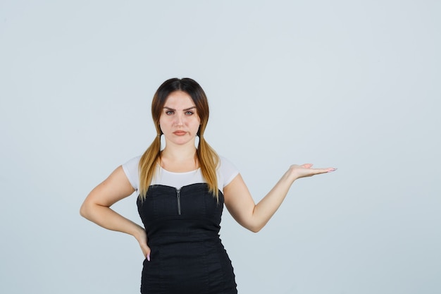 Free photo blonde young lady in dress gesturing isolated