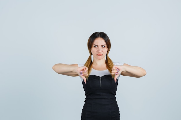 Free photo blonde young lady in dress gesturing isolated