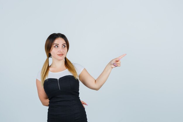 Blonde young lady in dress gesturing isolated