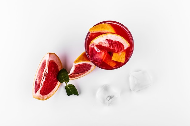 Blood orange gin and tonic cocktail served with slices of orange and ice in a glass 