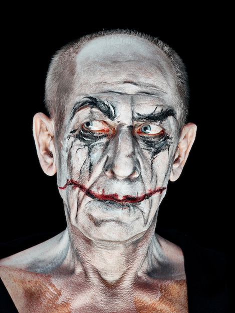 Bloody Halloween theme: The crazy maniak face on dark studio