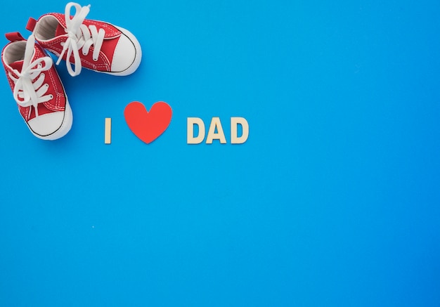 Blue background with shoes and heart for father's day