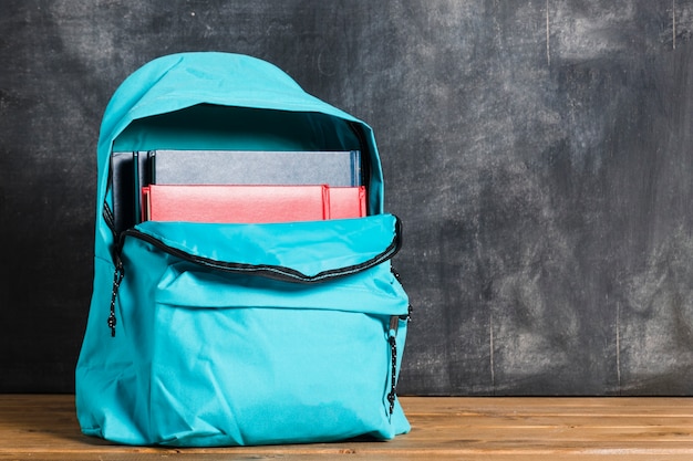 Free photo blue backpack with textbooks