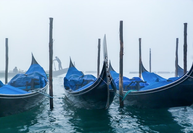 Free Photo blue boats parked and a foggy white sky