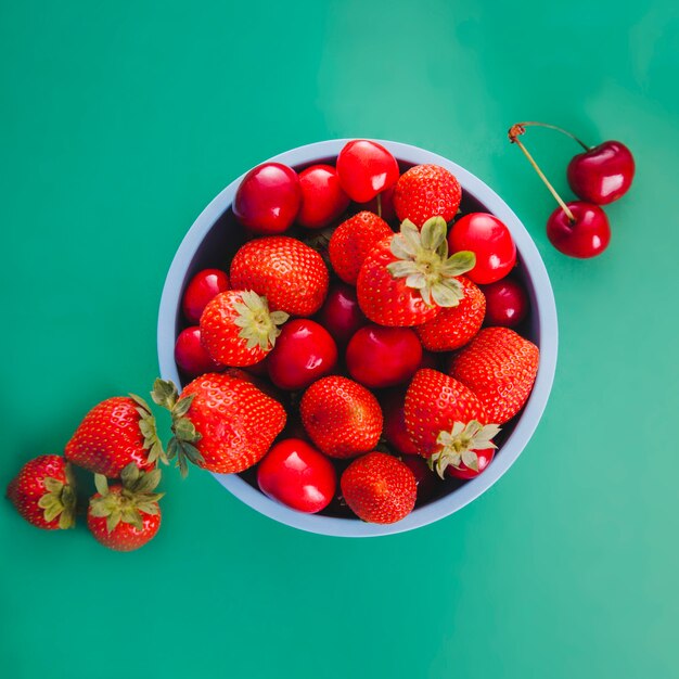 Blue bowl with red fruits