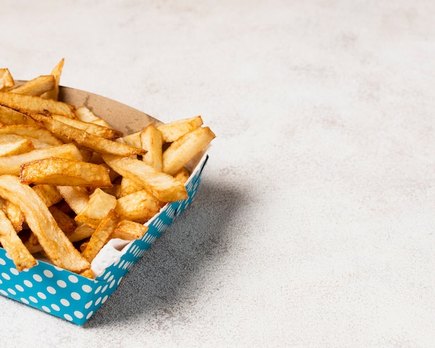 Free Photo blue box of french fries with copy space