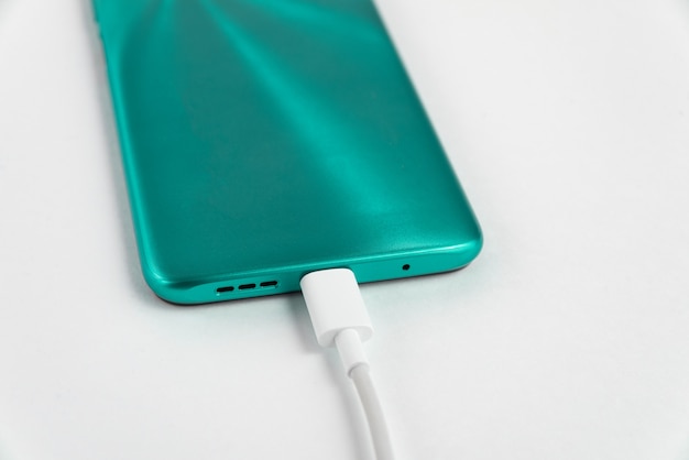 Blue cell phone connected to USB cable type C - Charging