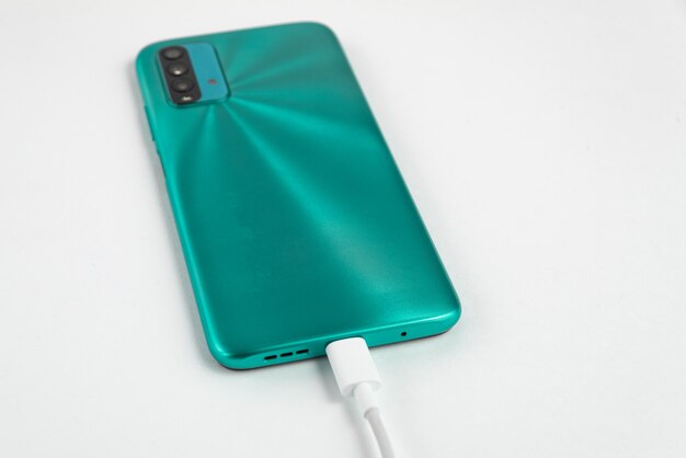 Blue cell phone connected to USB cable type C - Charging