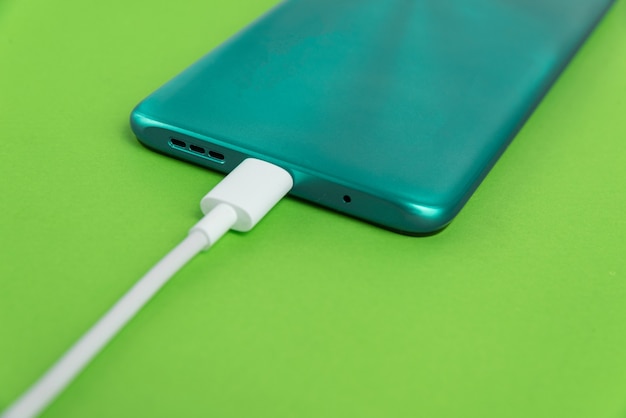 Blue cell phone connected to USB cable type C - Charging