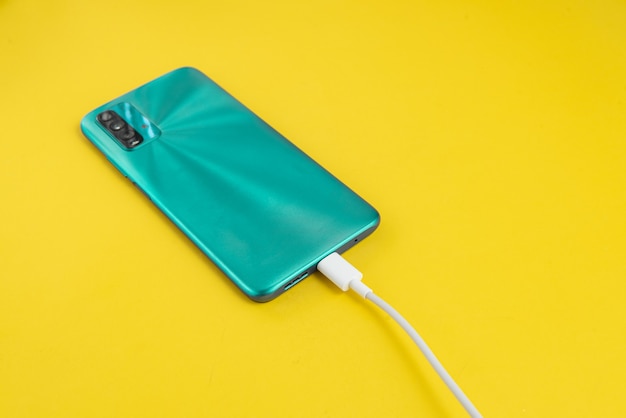 Free photo blue cell phone connected to usb cable type c - charging