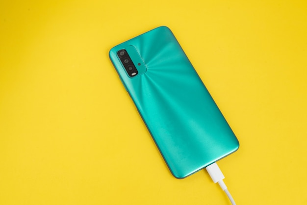 Blue cell phone connected to USB cable type C - Charging