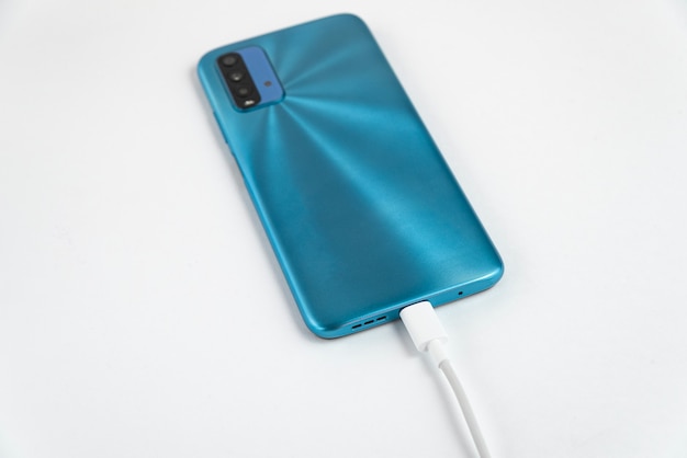 Free photo blue cell phone connected to usb cable type c - charging