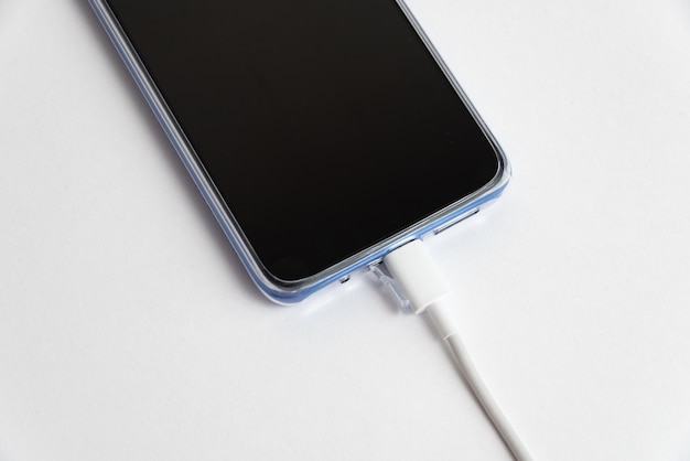 Free photo blue cell phone connected to usb cable type - charging