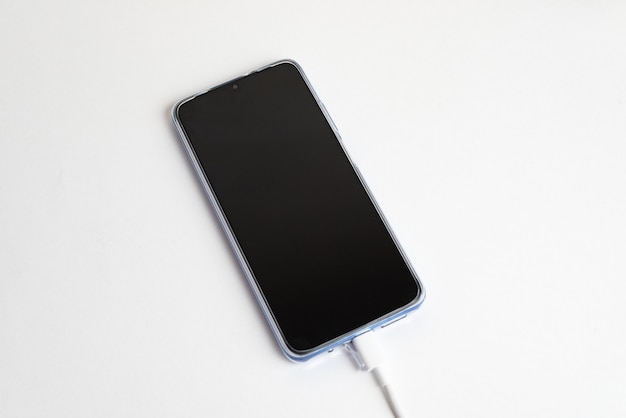 Blue cell phone connected to USB cable type - Charging