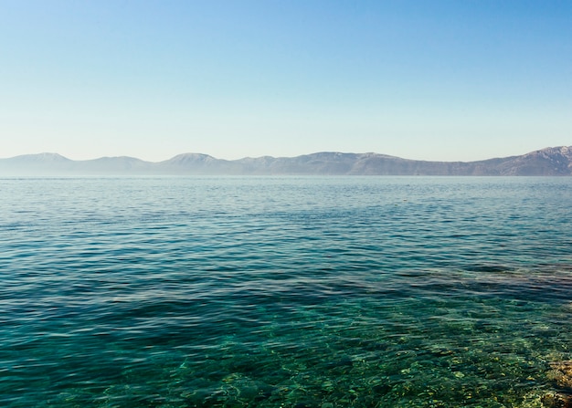 Free Photo blue crystal idyllic lake with mountain range against blue sky