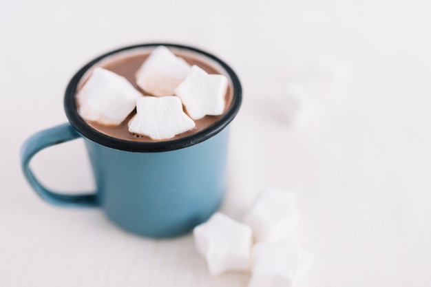 Blue cup with cocoa and marshmallows 