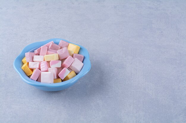 A blue deep plate full of colorful sweet confectionery Pastila . 