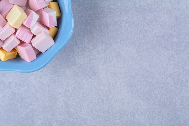 A blue deep plate full of colorful sweet confectionery Pastila 