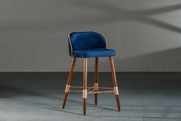 Blue dining room chair in a room with gray walls