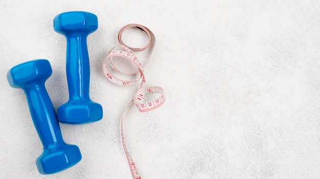 Blue dumbbells on stucco background