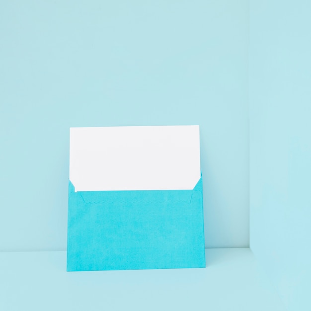 Free photo blue envelope with blank paper inside