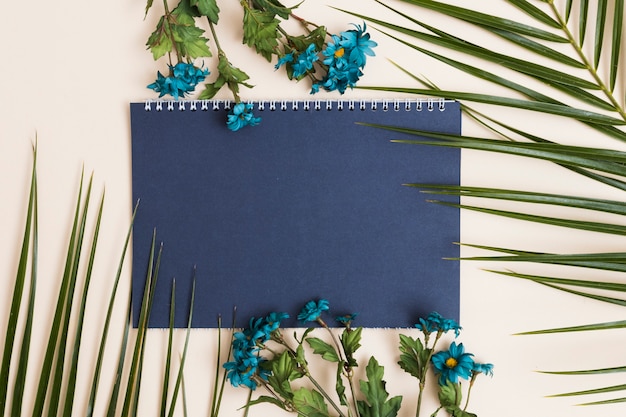 Free photo blue flowers and notepad