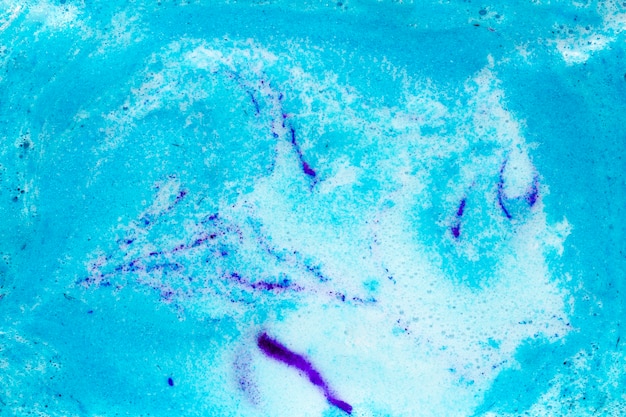 Free photo blue foam on liquid with paint