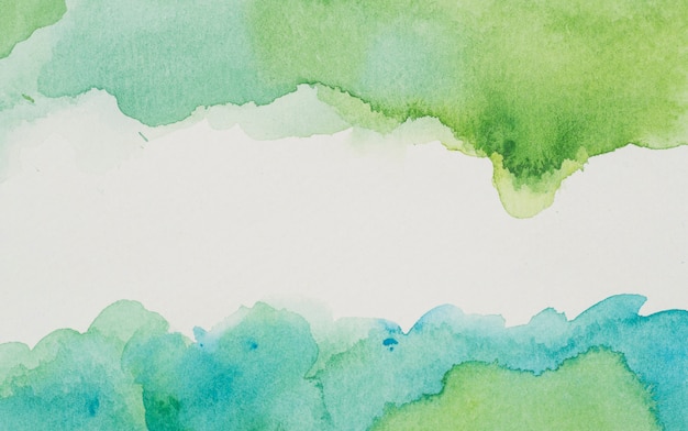 Blue and green paints on white paper