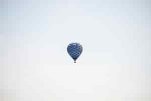 Free photo blue hot air balloon flying in the sky