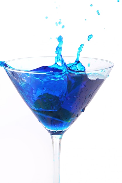 Blue liquid pouring into glass