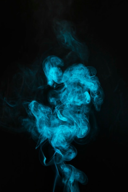 Blue mist blowing smoke on black background