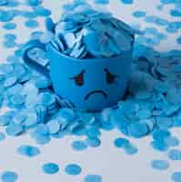 Free photo blue monday with paper rain and crying mug