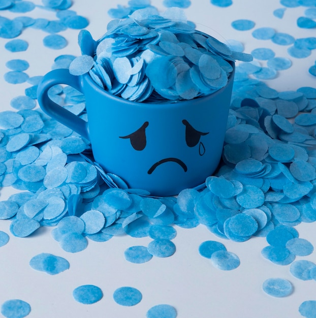 Free Photo blue monday with paper rain and crying mug