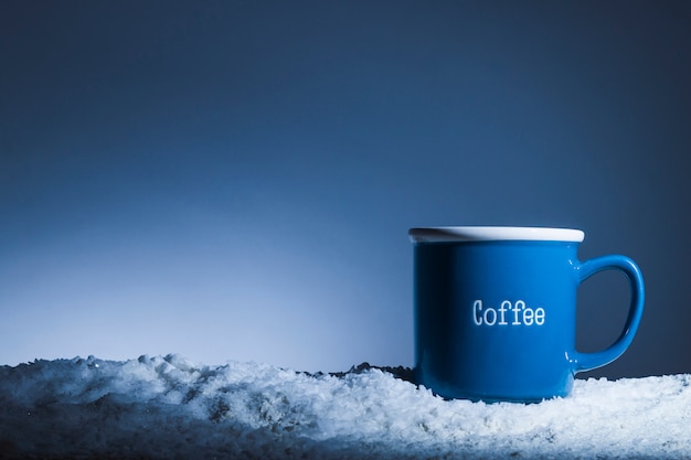 Blue mug on bank of snow