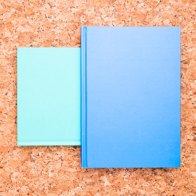 Free Photo blue notebooks on wooden desk