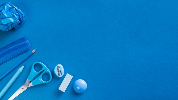 Free photo blue office utensils on desk