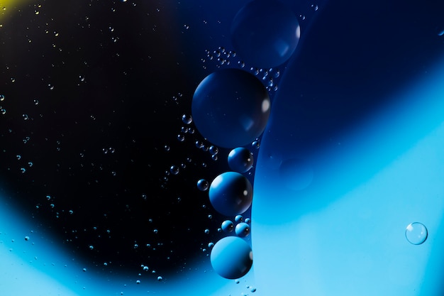 Free Photo blue oil drops on a water surface abstract background