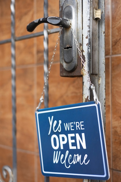 Free Photo blue open sign hanging on doorknob