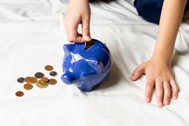 Blue piggy bank filled with coins