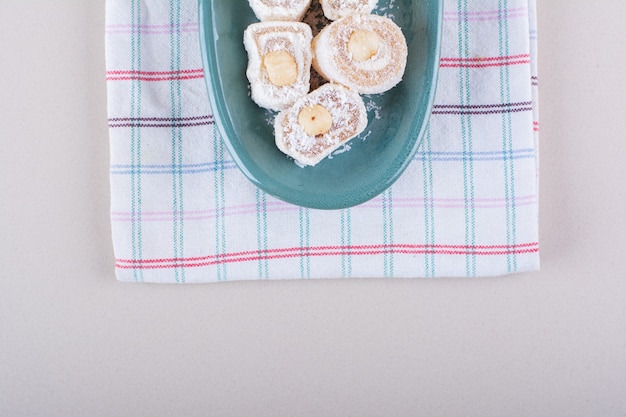 Free Photo blue plate of sweet lokum dessert on marble background. high quality photo