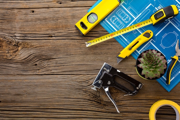 Free Photo blue print and set of tools on wooden background