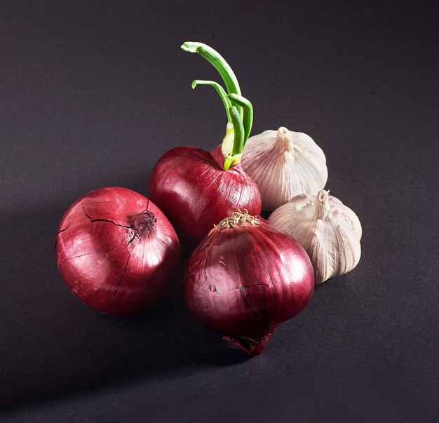 Blue purple onion and garlic isolated white on a black