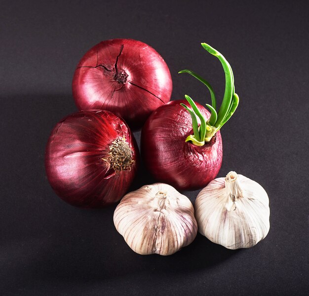 Blue purple onion and garlic isolated white on a black