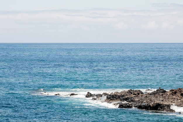 Blue sea with rocky littoral